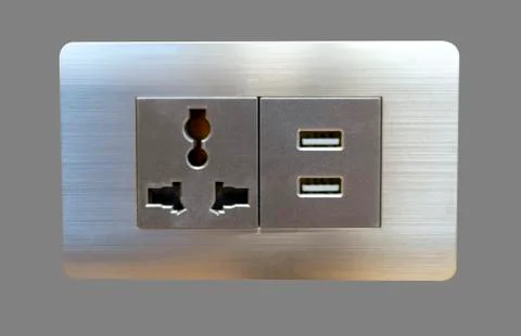 Electric wall plug socket and USB charging port isolate on gray bakcground. Stock Photos