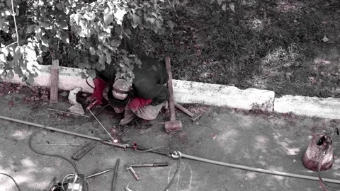 An electric welder performs work on welding metal rods Stock Footage 246438471