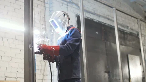 Electric welding of metal structures in specialized clothing and mask Stock Footage 88588450
