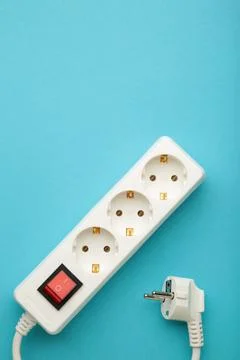 Electric white portable socket on blue background Stock Photos