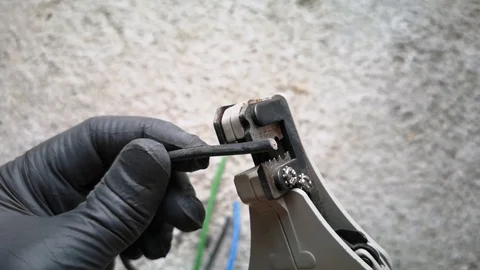 Electric workers stripping electrical cable insulation using special tools Stock Footage 124413573