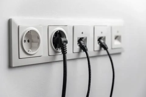 Electrical and internet socket on a white wall in the room. Foto stock