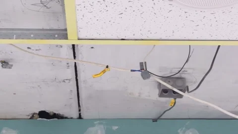 An electrical box and wires are fixed to the ceiling during renovation Stock Footage 340358379