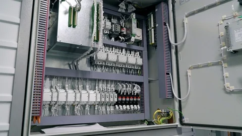 Electrical box contains many terminals, relays, wires and switches. Manufacture Video stock 105207585