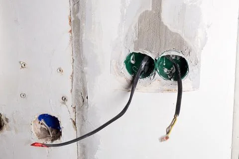 The electrical boxes for the wires are built into the wall, and the wires s.. 스톡 사진