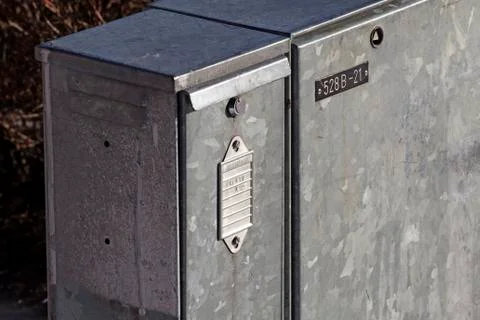 An electrical cabinet for various cables standing in the snow Stock Photos