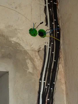 Electrical cable installation in wall during renovation with black wires Foto stock