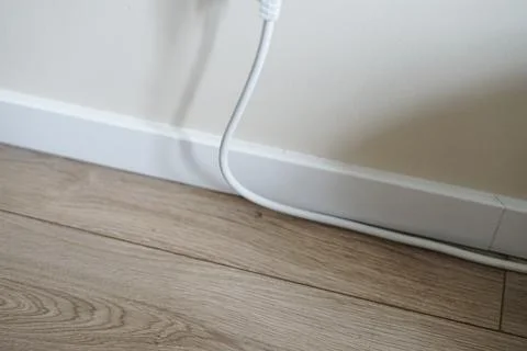 Electrical cable into the socket. Home shot. Stock Photos