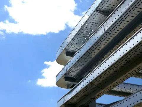Electrical Cable Trays Installed on a Building Under a Clear Blue Sky Stock Photos