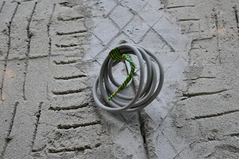 Electrical cable on an unfinished masonry wall Stock Photos