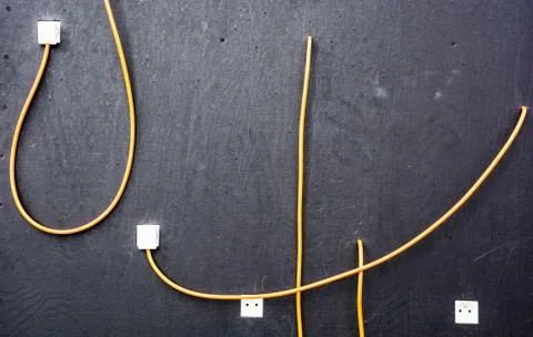 Electrical cables and sockets on the dark board Stock Photos