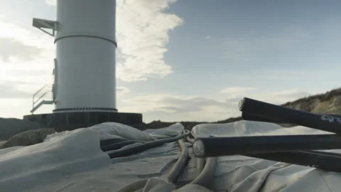 The electrical cables are routed out of the wind turbine's concrete foundation Video stock 347411162