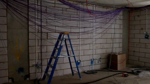 Electrical cables hanging down in new office build Stock Footage 112615046