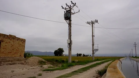 Electrical cables running through and over an irrigation canal, Stock Footage 103158626