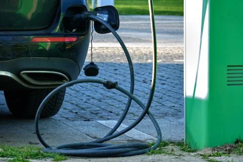 Electrical car charging battery while parking Stock Photos
