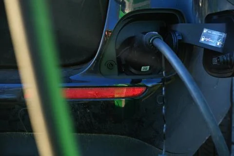 Electrical car charging battery while parking Stock Photos