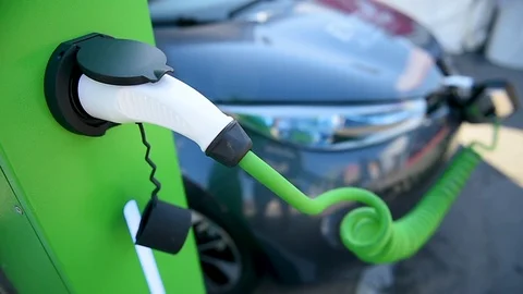Electrical car plugged through a charging cable to a charging station. 스톡 동영상 119074338