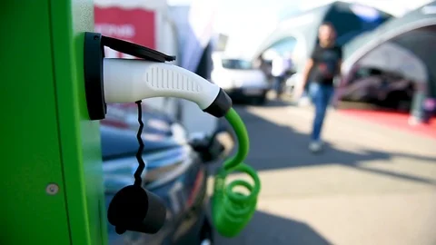 Electrical car plugged through a charging cable to a charging station. 스톡 동영상 119074360
