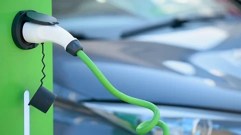 Electrical car plugged through a charging cable to a charging station. 스톡 동영상 119074406