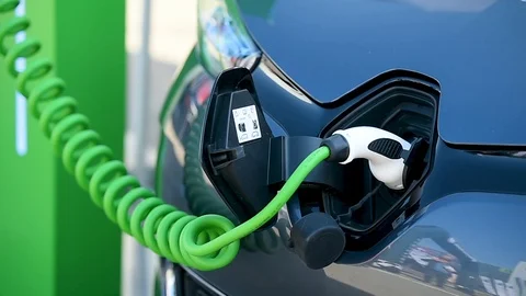 Electrical car plugged through a charging cable to a charging station. 스톡 동영상 119277483