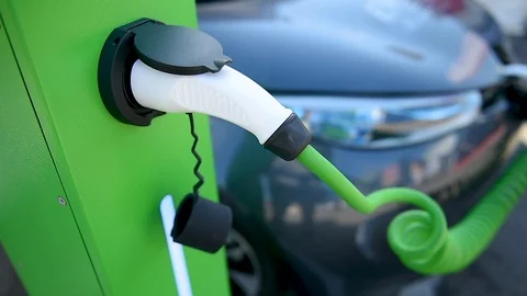 Electrical car plugged through a charging cable to a charging station. 스톡 동영상 119277569