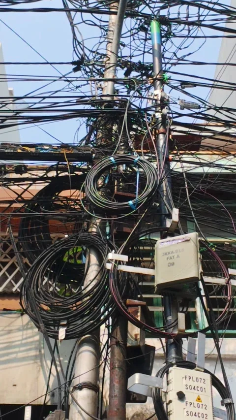Electrical Chaos on display as tangled cables sway in wild puzzled array Stock Footage 323783916