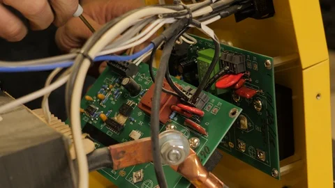 Electrical circuit board being worked on by a technician. Stock Footage 97359406