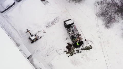 Electrical company's worker crew digging hole for utility pole near Stock Footage 228353191