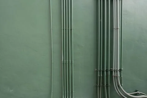 Electrical conduit system with tubes and electric cables on building wall. .. Stock-Fotos