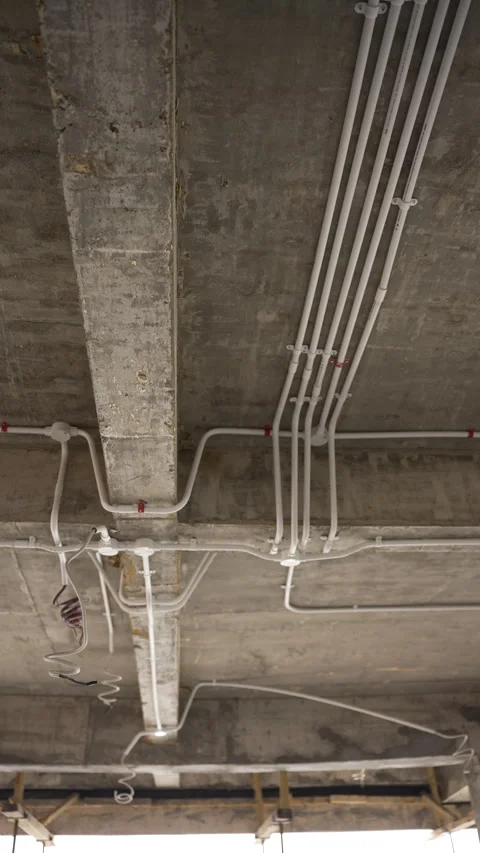 Electrical conduits and bare ceilings in a building under construction Stock Footage 270360527
