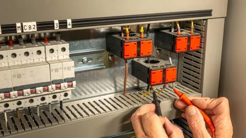 Electrical contractor engineer testing current transformers in an HVAC panel 스톡 사진