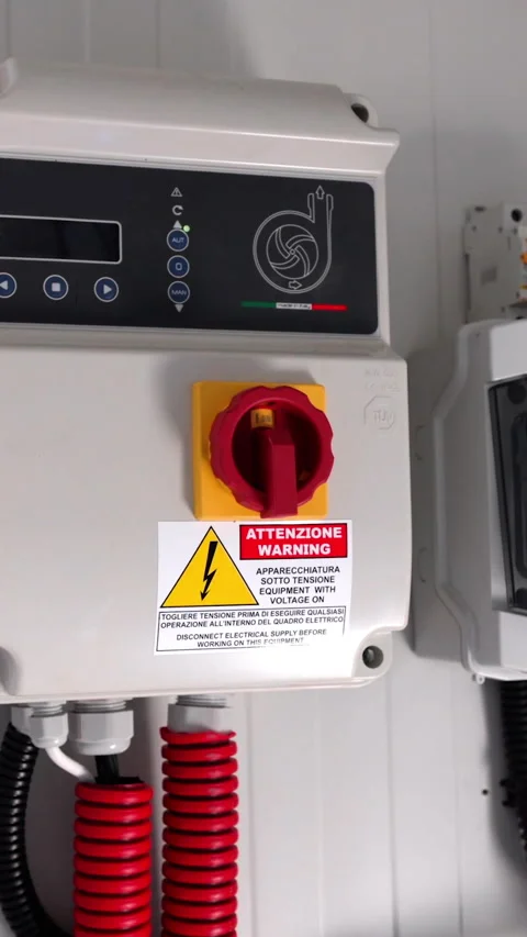 Electrical control panel with visible red emergency stop button and warning Stock Footage 338398167