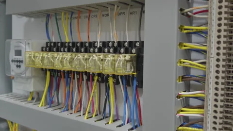 Electrical Control Panel with Yellow Relays and Colorful Wiring 库存影片 337440001