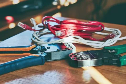 Electrical crimp tools and wire on the office table in sunlight toned Stock Photos