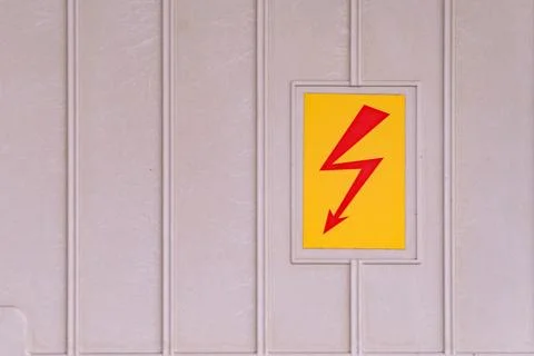 Electrical danger warning symbol with a red lightning bolt on a yellow back.. Stock Photos