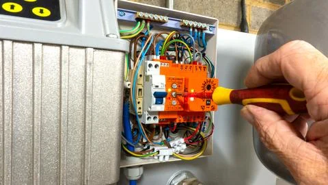 Electrical engineer adjusting an eco-friendly water irrigation pump Stock Photos