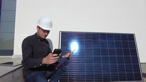 Electrical engineer analysing data on solar panels, home installation Stock Footage 194411665