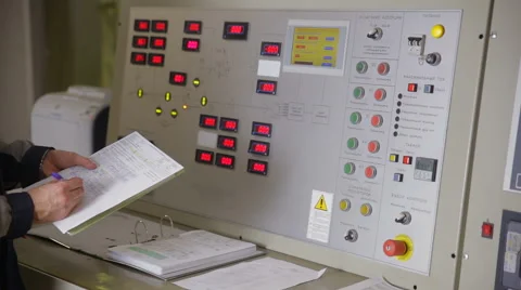 Electrical engineer checking parameters at a control panel of a nuclear plant Stock Footage 68806458