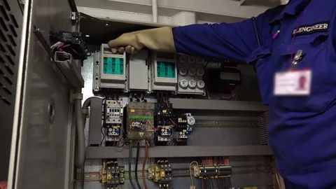Electrical engineer checks appliances in engine control room Stock Footage 121119149