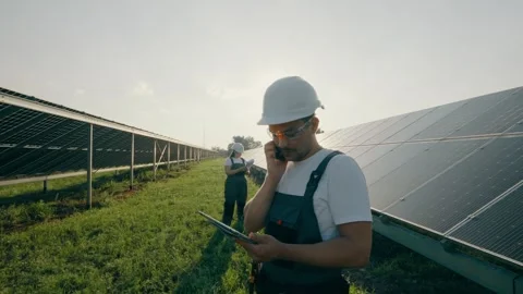 An electrical engineer discusses the operation of solar powerplants on the phone Stock Footage 257133645