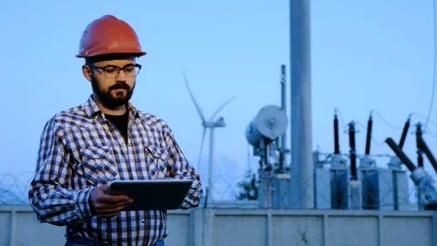 An electrical engineer in the evening at the substation. Video stock 95628697