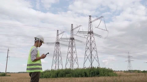 An electrical engineer forcing a drone To inspect high voltage poles before Stock Footage 159201322