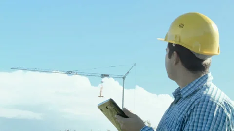 Electrical Engineer in front of a crane. Construction site. Stock Footage 32185690