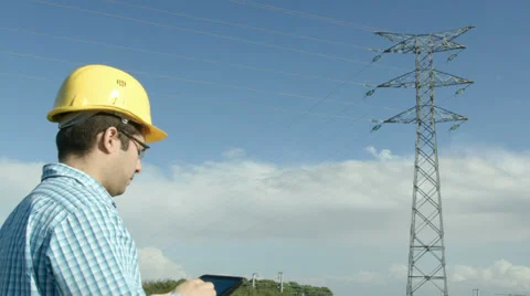 Electrical engineer in front of a power line. Stock Footage