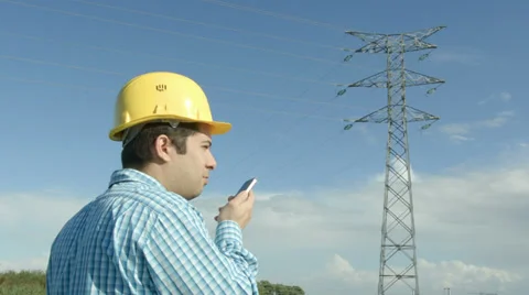 Electrical engineer in front of a power line. Stock Footage 32187983