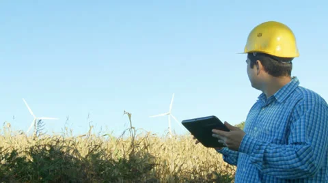 Electrical Engineer in front of a Windmill turbines field. Stock Footage 32185841
