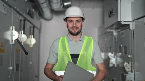 Electrical Engineer Inspects Modern Electrical Control Panel in Switchboard Room Stock Footage 297842903