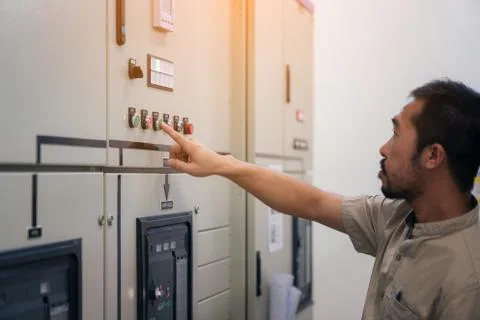 Electrical engineer man checking voltage and test at the Power Distribution C Stock Photos