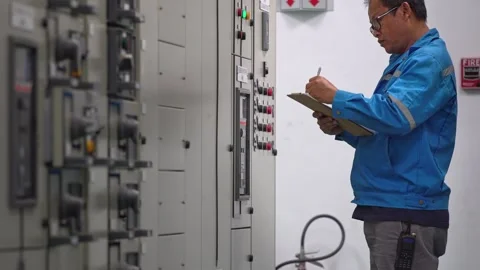 Electrical Engineer Measuring and Inspecting Power Energy Data from Control Pane Stockbeeldmateriaal 343904616