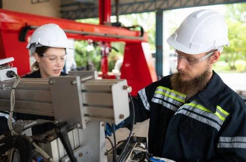 Electrical engineer with the mission of installing a robot arm electrical ... Stock Photos